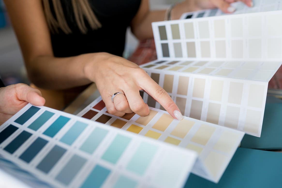 woman choosing colors for retail storefront painting